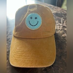 Gold ball cap with blue smiley patch, new!